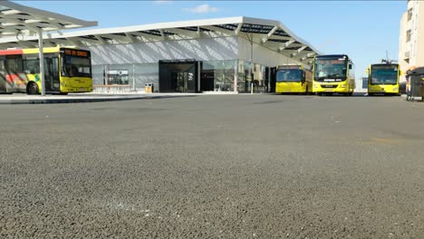 City-buses-arriving-and-leaving-at-bus-station-near-the-railway-station-of-Namur,-Belgium---Wide-angle-shot