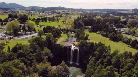 Beautiful-waterfall-in-city-park-aerial-orbit-shot