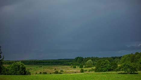Beautiful-rainbow-disappear-in-extreme-dark-thunder-clouds,-time-lapse-view