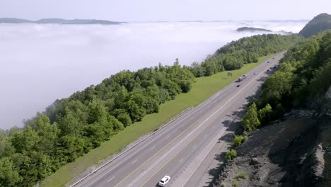 Clouds-and-fog-along-with-traffic-on-Interstate-75-near-Jellico,-Tennessee-in-the-Cumberland-Mountains-with-drone-video-stable-up-high