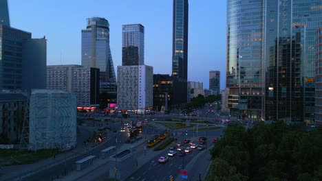 Aerial-view-of-Warsaw-city-center-during-the-blue-hour,-circling-around-Rondo-ONZ-with-modern-office-buildings-and-stunning-reflections