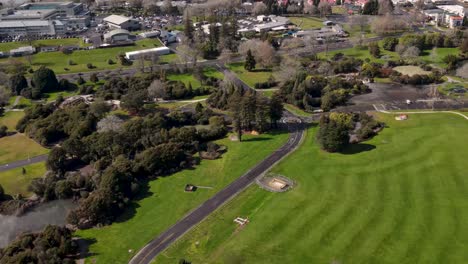 Beautiful-aerial-scenic-view-from-Kuirau-Park-to-lakefront-and-Rotorua-city-centre-during-sunny-day,-New-Zealand