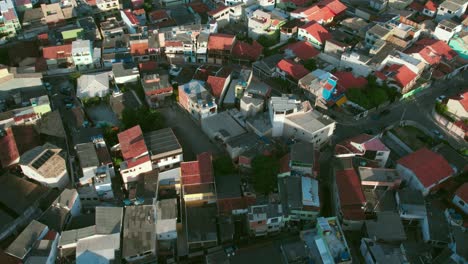 Aerial-view-rising-above-low-income-residential-area-property-rooftops-in-Arraial-do-Cabo,-Rio-de-Janeiro