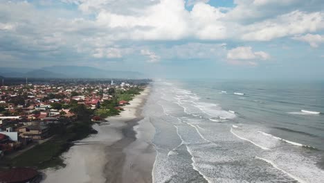 Slow-motion-aerial-shot-of-beautiful-beach-on-Atlantic-ocean-in-Brazil-stunning-sky-and-clouds