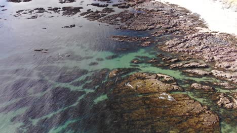 Aerial-Pan-Up-View-Along-Thurlestone-Coastline-During-Low-Tide