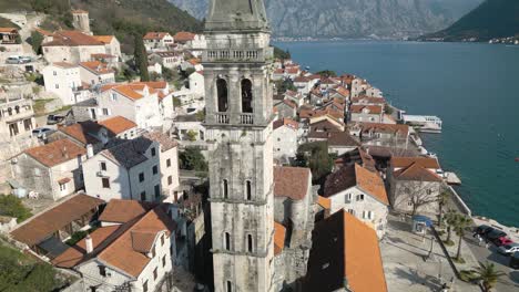 Close-Up-Aerial-View-of-Perast-Church-and-Clock-Tower