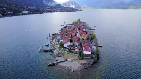 Drone-ascent-focusing-on-Superiore-island-with-small-medieval-picturesque-village-on-it