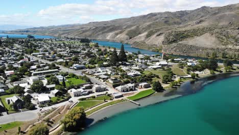 Cromwell,-New-Zealand,-Drone-Aerial-View-of-Small-Town-by-Clutha-River-on-Sunny-Summer-Day,-Cityscape-and-Skyline