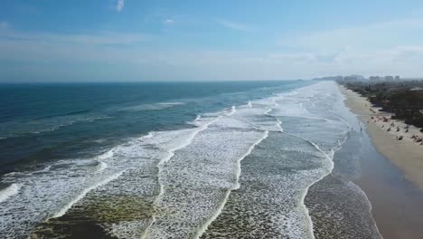 Incredible-establishing-panorama-shot-of-big-waves-and-beach-in-Itanhaem,-Brazil,-great-color-of-ocean-and-clouds