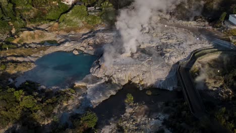 Clouds-rising-from-the-geothermal-vents-in-Whakarewarewa,-New-Zealand--Aerial