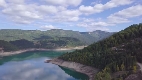 Stunning-4k-aerial-shot-of-green-forest-and-blue-Lake-Zaovine,-Tara-mountain