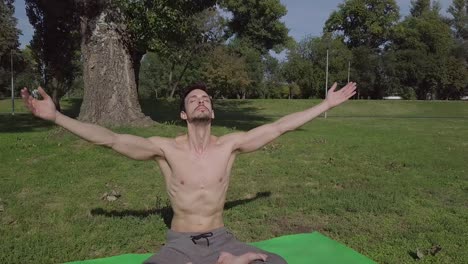Young-yogi-athlete-sitting-and-doing-yoga-exercises