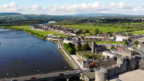 Aerial-View-of-Limerick,-Republic-of-Ireland,-Shannon-River,-King-John's-Castle-13th-Century-Fortress-and-City-Landmark-on-Sunny-Summer-Day