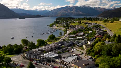 Beautiful-lakefront-with-hotels-and-small-port-on-Lake-Wanaka,-New-Zealand-famous-destination
