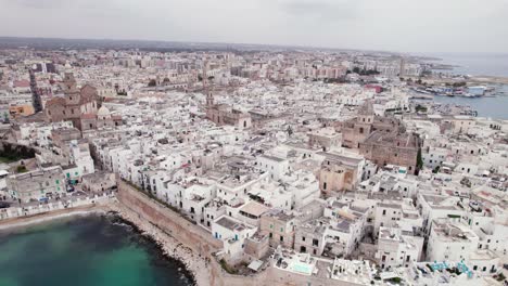 Aerial-view-of-Monopoli-old-city-with-white-building-on-sea-coast,-Puglia,-Italy