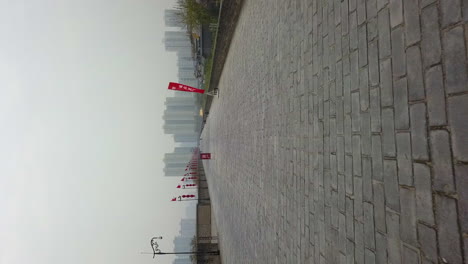 Low-vertical-POV-flight-along-top-of-old-city-wall-in-Xi'an,-China