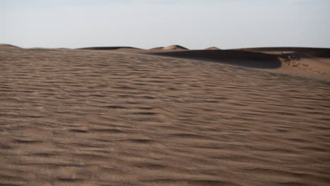 Slow-motion-sand-blowing-in-a-desert