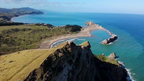 Outstanding-view-of-New-Zealand-coastal-panorama,-sandy-beach-in-bay,-surrounded-by-rocky-reef