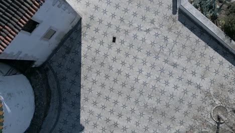 aerial-view-of-tourists-walking-on-the-traditional-Lisbon-floor,-featuring-the-city's-typical-ornaments-and-patterns
