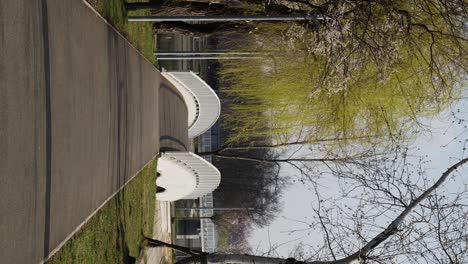 Vertical-Shot-Of-Asphalt-Alley-And-Small-Bridge-In-The-Park