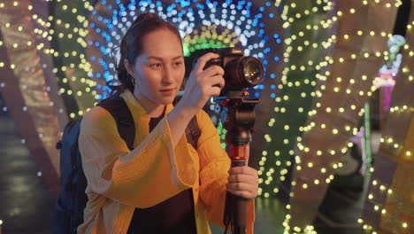 Female-Photographer-Capturing-Pictures-At-Night-With-Camera-Mounted-On-A-Tripod