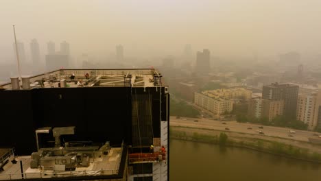 Construction-workers-working-in-toxic,-polluted-environment-of-a-large-city---Aerial-view