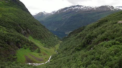 Mountain-river-flows-into-lake-Norway