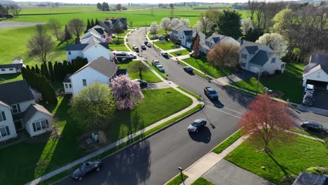 Aerial-establishing-shot-of-cars-and-vehicles-driving-in-USA-neighborhood-in-spring