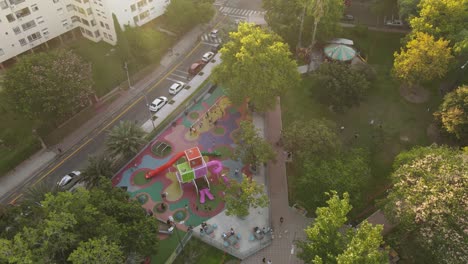 Drone-birds-eye-of-playing-children-on-playground-near-Apartment-blocks-in-Buenos-Aires