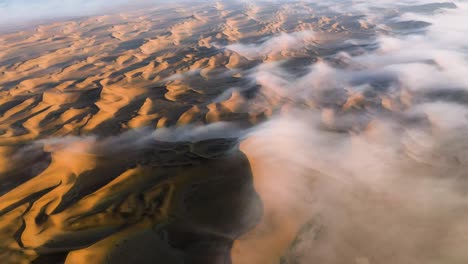 Aerial-view-titing-over-endless,-Namib-desert-dunes,-foggy-morning-in-Namibia