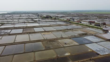 Aerial-drone-view-of-view-of-the-vast-expanse-of-salt-ponds-in-Jepara,-Central-Java,-Indonesia