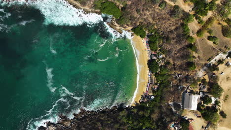 Aerial-view-above-the-Playa-Carrizalillo-beach-in-sunny-Puerto-Escondido,-Mexico---top-down,-drone-shot