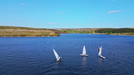 Winscar-reservoir-in-Yorkshire-transforms-into-a-lively-venue-for-sailing-enthusiasts,-where-small-one-man-boats-participate-in-an-exciting-racing-event