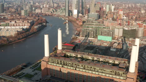 Cinematic-circling-reveal-aerial-shot-from-Battersea-Power-station-towards-central-London
