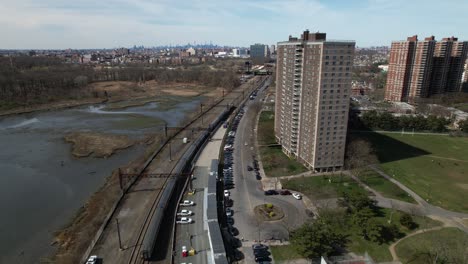 An-aerial-view-of-a-train-traveling-in-The-Bronx,-New-York-on-a-sunny-morning