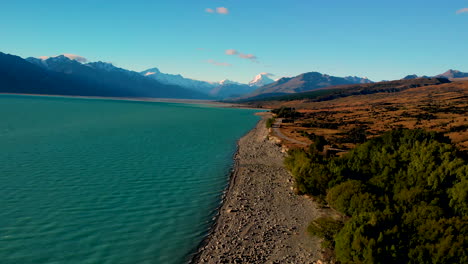 Aerial-above-Lake-Pukaki-shore,-beautiful-colours,-Mt