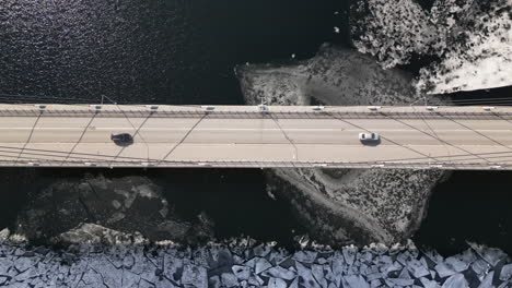 Cars-passing-over-bridge,-icy-landscape