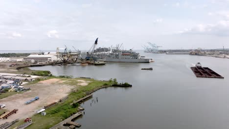 Barge-and-shipyard-in-Mobile-Bay-in-Mobile,-Alabama-with-drone-video-moving-in