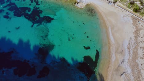 Drone-facing-down-over-small-beach