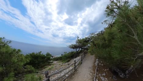Slow-Walk-Along-The-Seaside-In-Aliki-Archaeological-Site,-White-Marble,-Blue-Sky,-Rocky-Path,-Thassos-Island,-Greece,-Europe