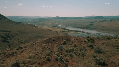 A-Caucasian-Young-Male-Embraces-the-Incredible-View-over-Thompson-River-Valley-from-Atop-Kamloops'-Majestic-Mountains
