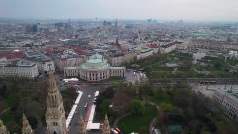 Aerial-revealing-shot-of-the-Burgtheater-in-downtown-Vienna,-Austria