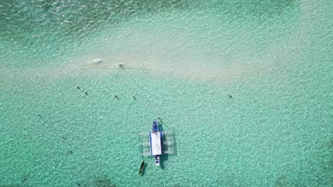 Top-down-perspective-overview-of-banca-outrigger-boat-in-balabac-sandbar-water