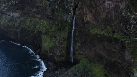 Experience-the-natural-beauty-of-the-waterfall-on-the-Madeira-cliff-with-breathtaking-drone-footage-from-Miradouro-do-Véu-da-Noiva