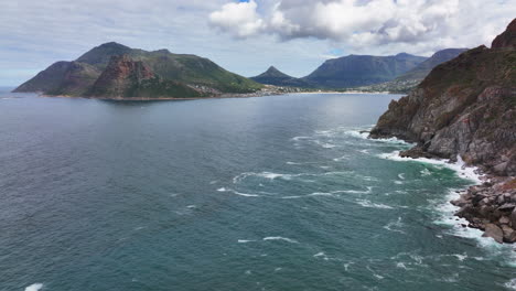 Chapman-Peak-South-Africa-aerial-cinematic-drone-Hout-Bay-marina-Cape-Town-Fish-Hoek-Good-Hope-Simon's-Town-waves-crashing-rugged-coast-stunning-aqua-deep-blue-water-lush-green-spring-summer-upward