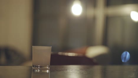 Scented-Candle-On-Wooden-Table-Inside-The-House-At-Night