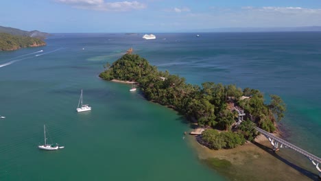 Aerial-view-of-Samana-Bridge-and-sailboats,-Dominican-Republic--drone-shot