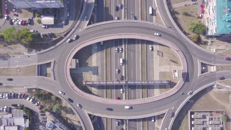Descending-aerial-shot-of-Roundabout-and-highway,-4k-traffic