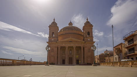 Iconic-church-of-small-Maltese-town-on-sunny-day,-time-lapse-view