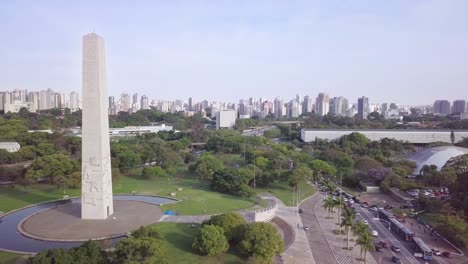 Obelisco-monument-and-buildings-in-Sao-paolo's-business-center-near-Avenida-Paulista--long-aerial-slow-moving-drone-shot